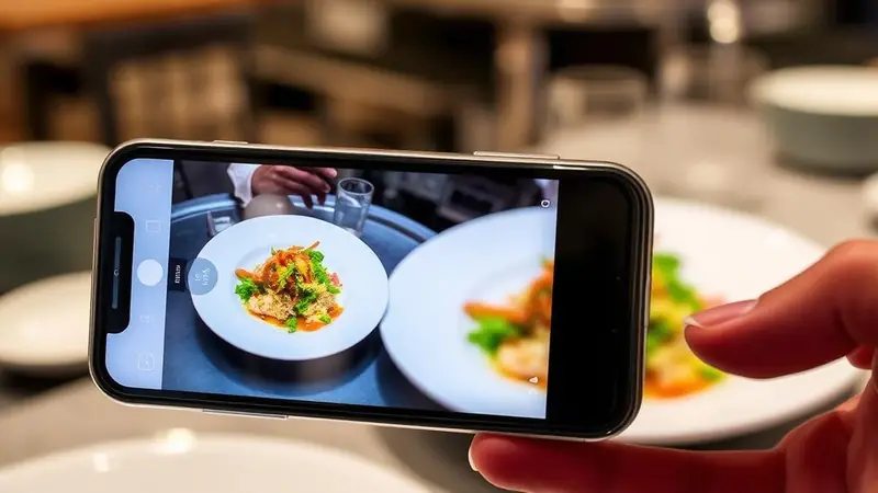 Restaurant chalkboard menu next to a phone showing an outdated Google Business Profile menu